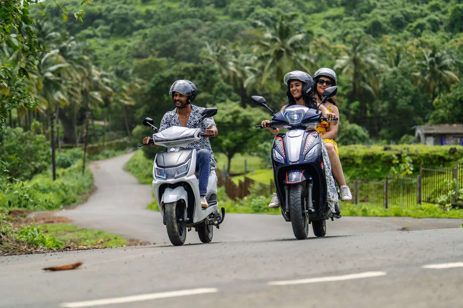Friends riding Tunwal scooters together on a country road